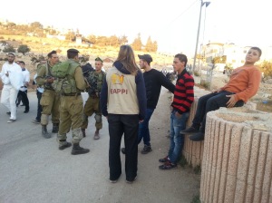 Me intervening to stop Israeli soldiers harassing young Palestinians who were sitting on a wall chatting as Israeli settlers walked past on Shabbat Chayei Sarah